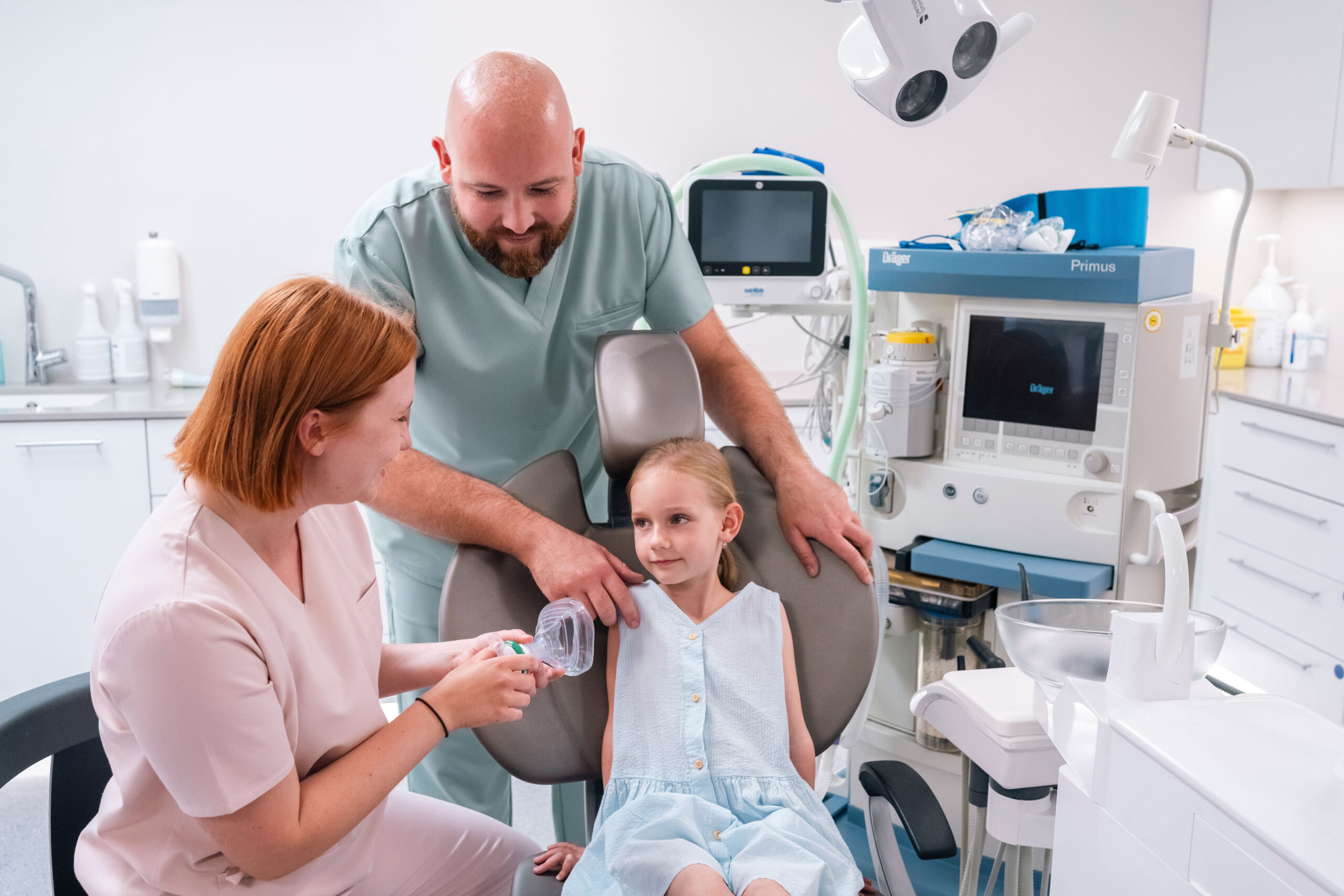Child being prepared for treatment with a calming mask in a dental clinic