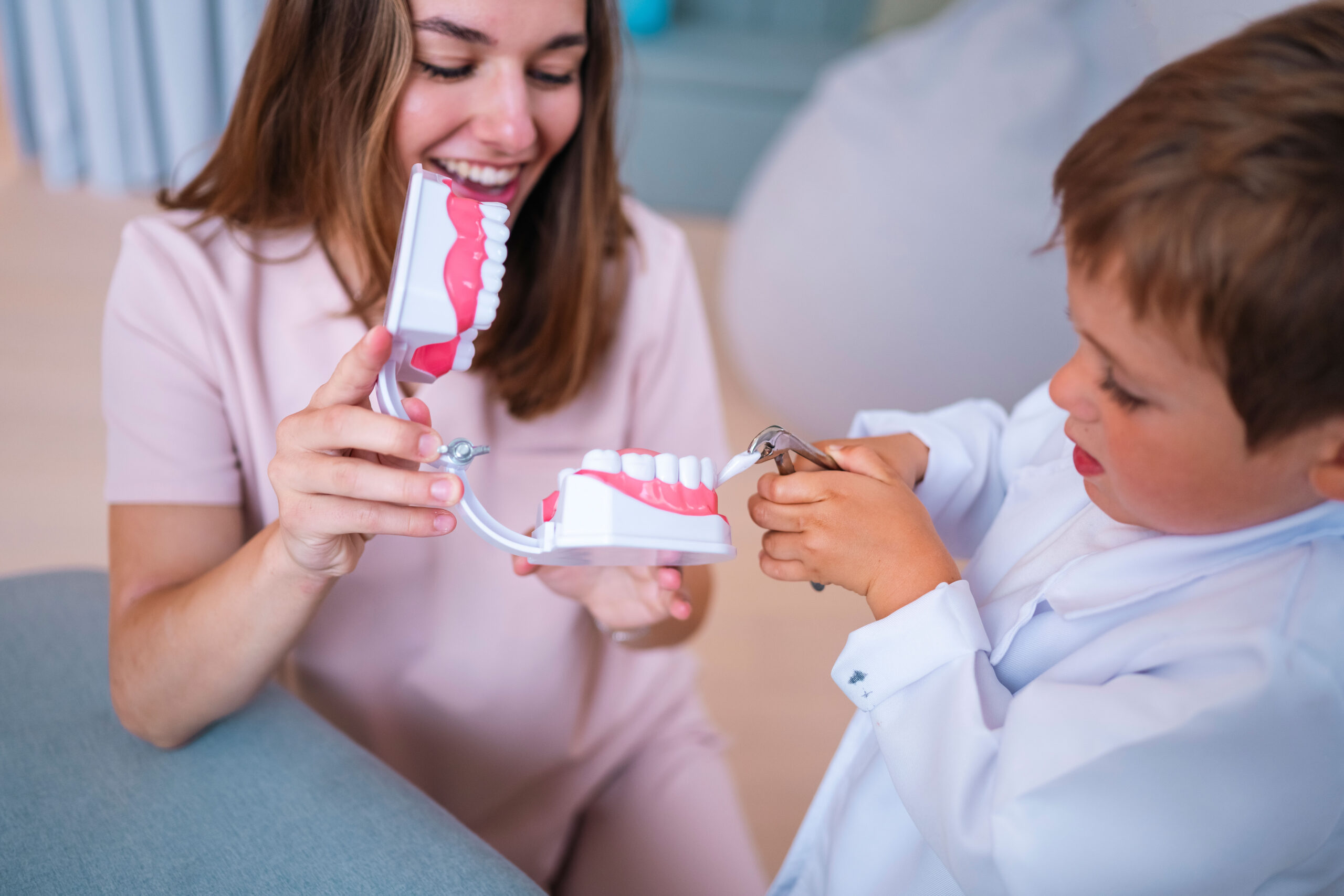 Child pretending to extract a tooth from a dental model