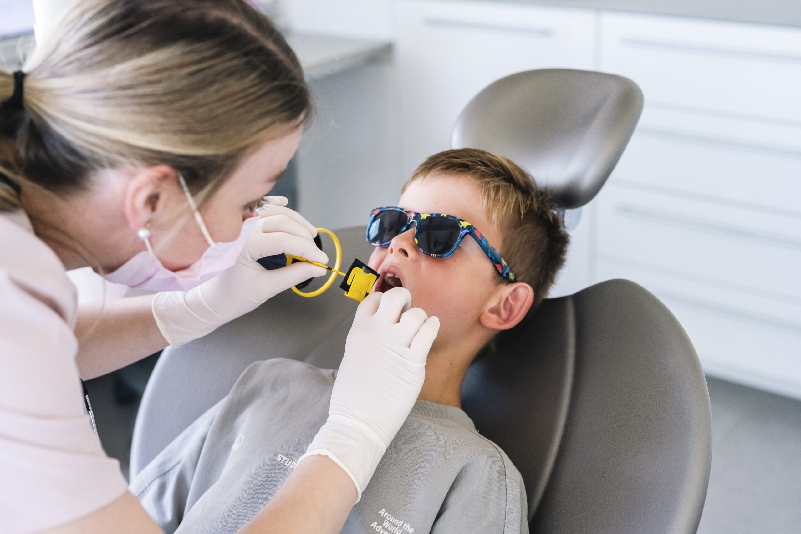 Dentist taking a bitewing X-ray of a child's teeth